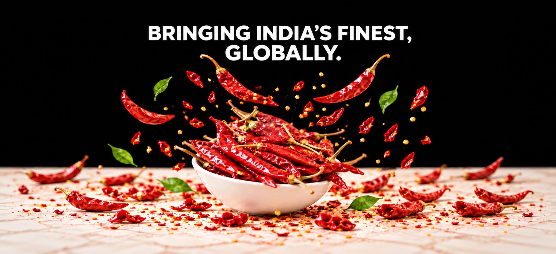 Bringing India's finest, globally. Dried red chillies spilling from a white bowl.